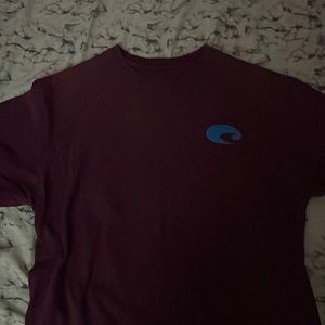 Dark burgundy mens costa t-shirt with blue and white detailing .
